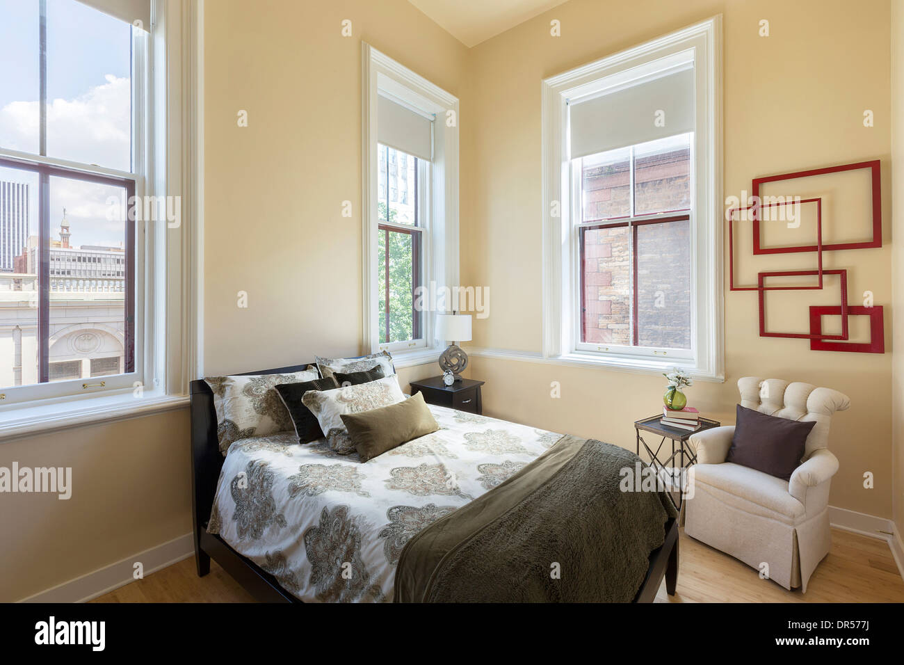 Bed and armchair in bedroom Stock Photo Alamy
