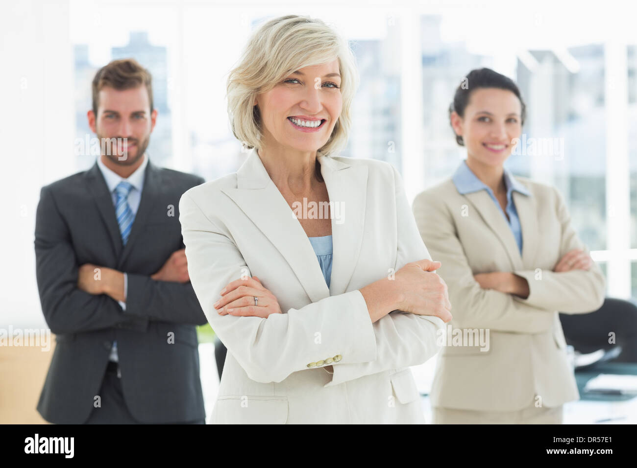 Confident business team with arms crossed in office Stock Photo - Alamy