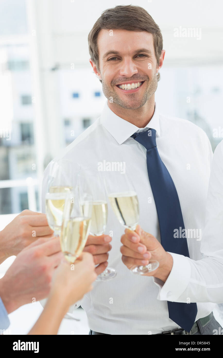 Businessman toasting with champagne in office Stock Photo Alamy