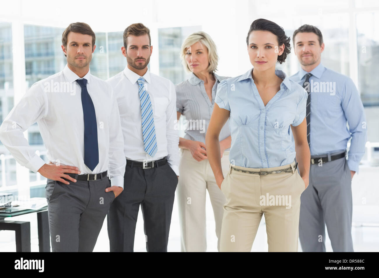 Confident business team together in office Stock Photo - Alamy