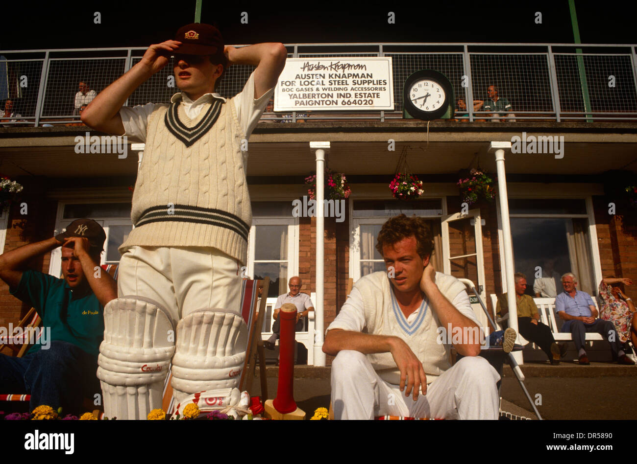 A batsman prepares to walk on to the field during a local club match in Paignton, UK. Stock Photo