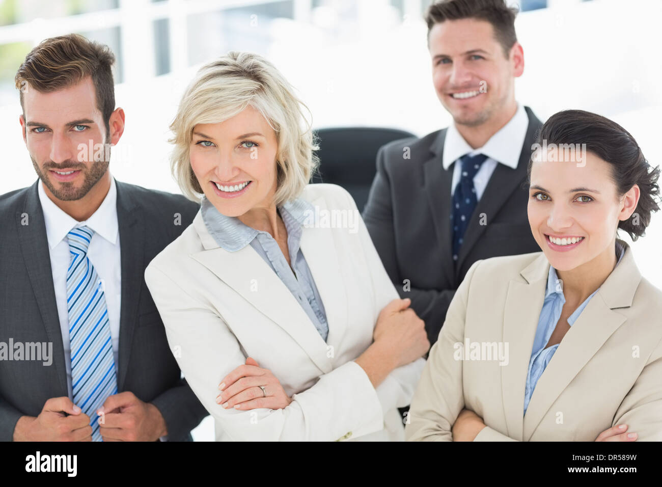 Confident business team with arms crossed in office Stock Photo - Alamy