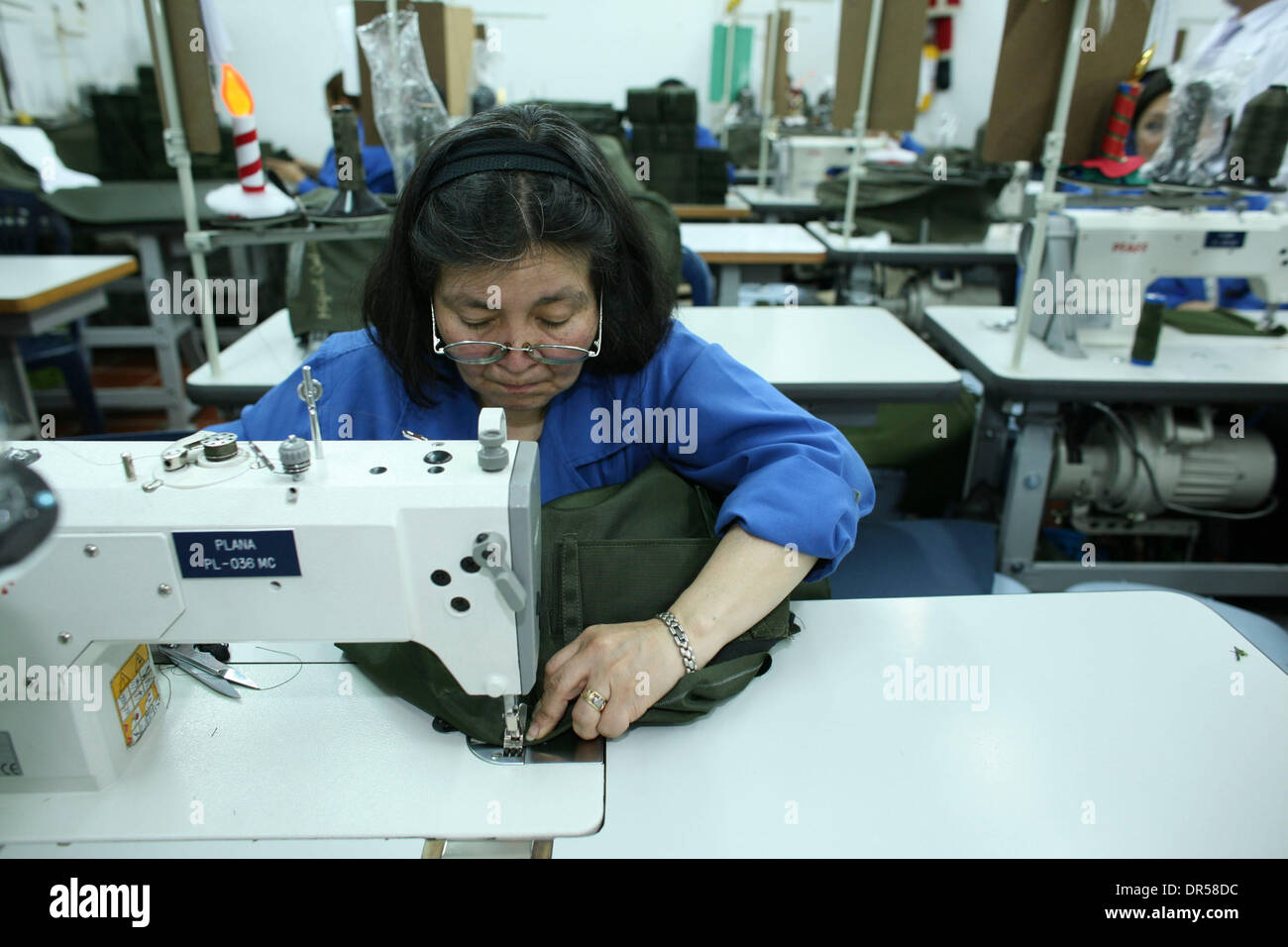 Dec. 15, 2008 - Bogota, Colombia - Clothing is trimmed in a workroom. Miguel Caballero specializes in bulletproof wear. The 'Armani' of firearm protection, Caballero's customers are presidents, politicians, royals and actors from Europe and the US. His special material can be suited to any outfit. Stock Photo