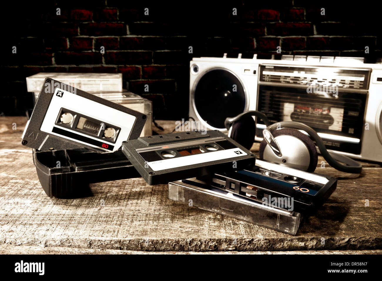 Old cassette tapes and cassette player on wooden surface Stock Photo