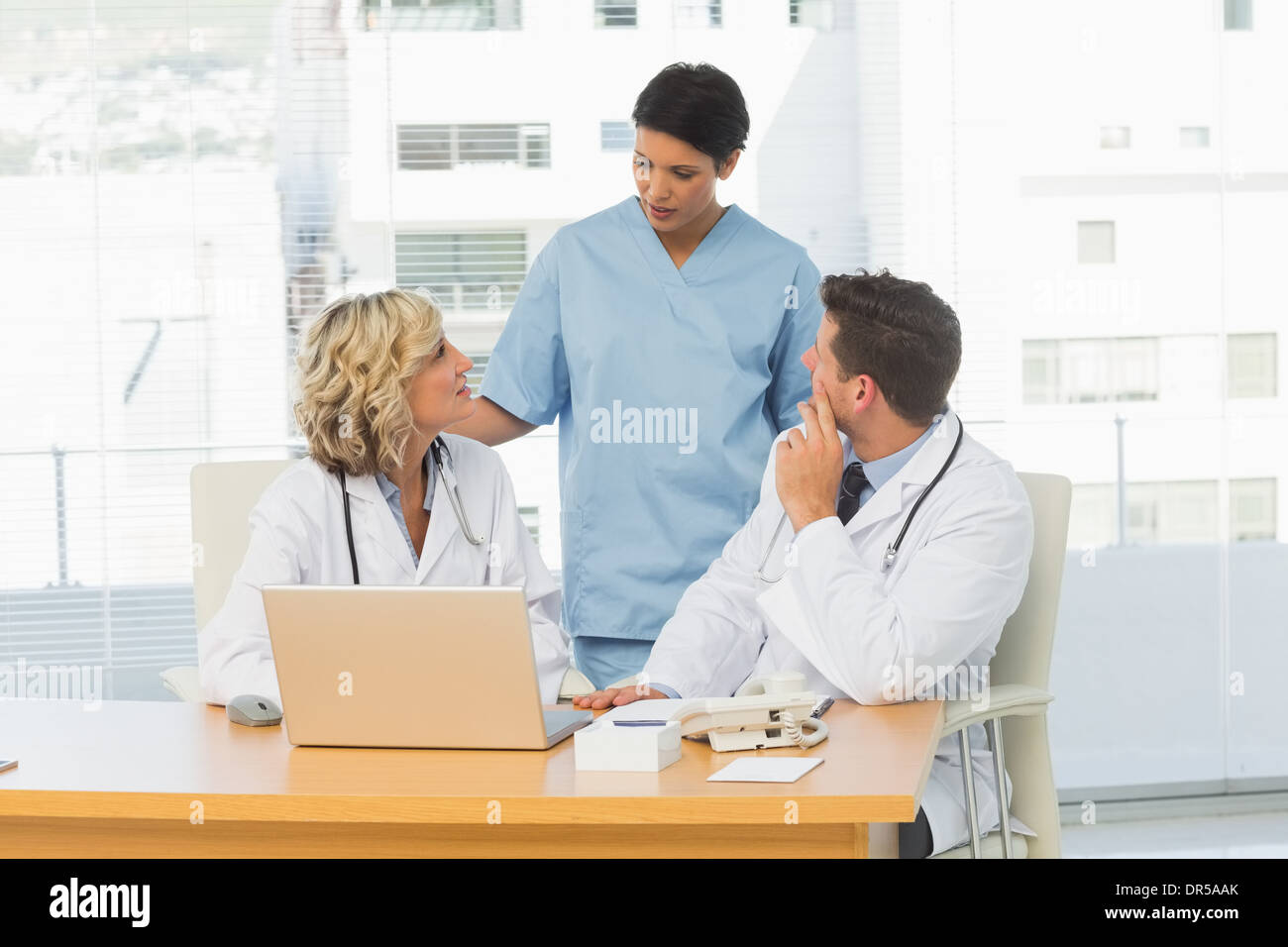 Three concentrated doctors in discussion Stock Photo