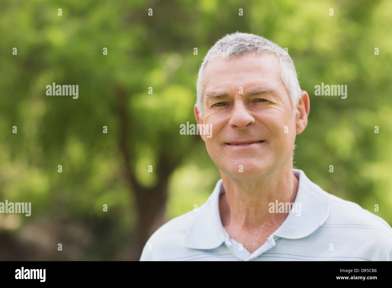 Portrait of a smiling senior man at park Stock Photo