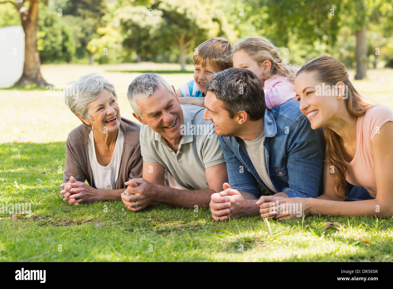 Family lying on grass hi-res stock photography and images - Alamy