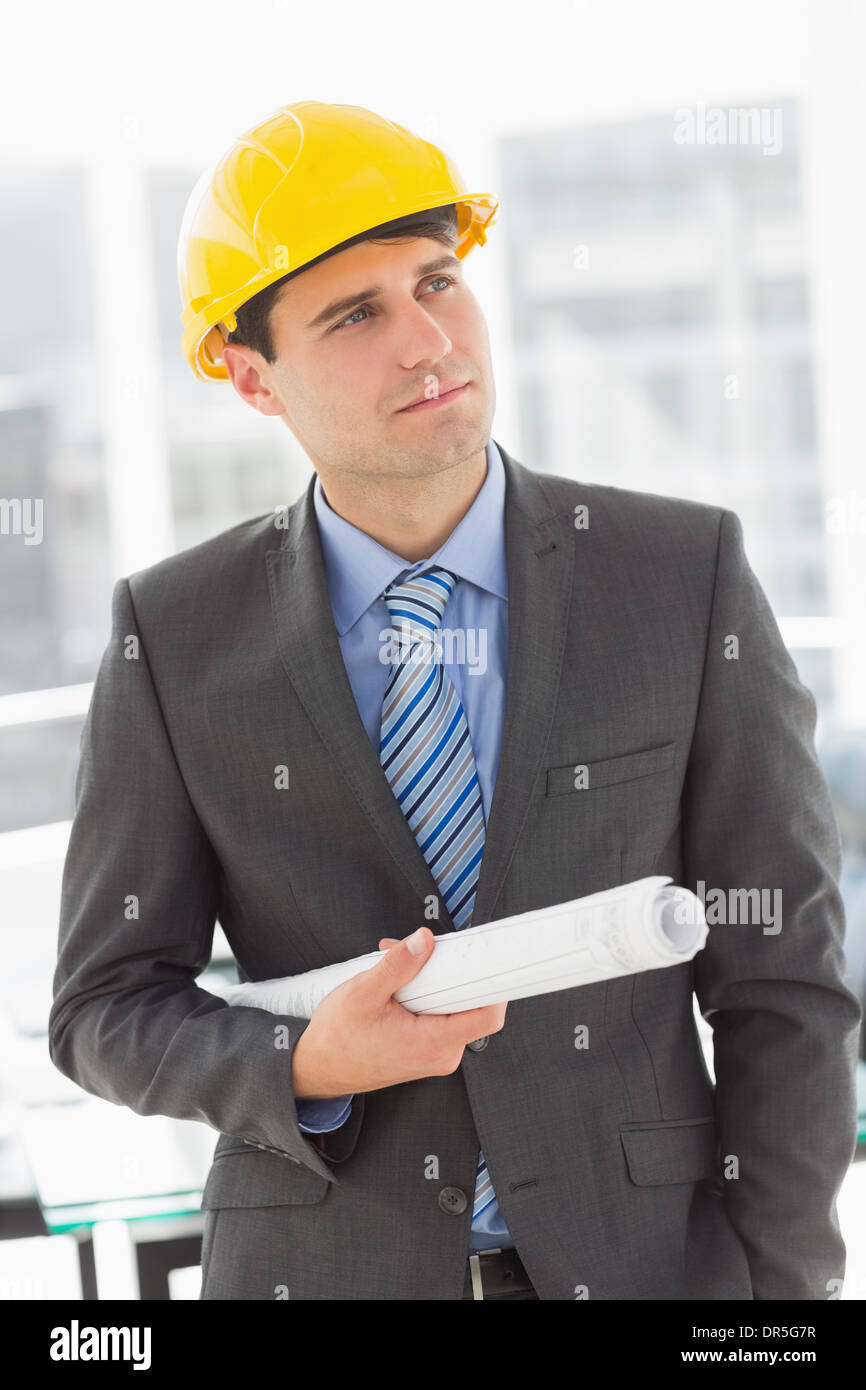 Happy architect thinking and holding blueprints Stock Photo