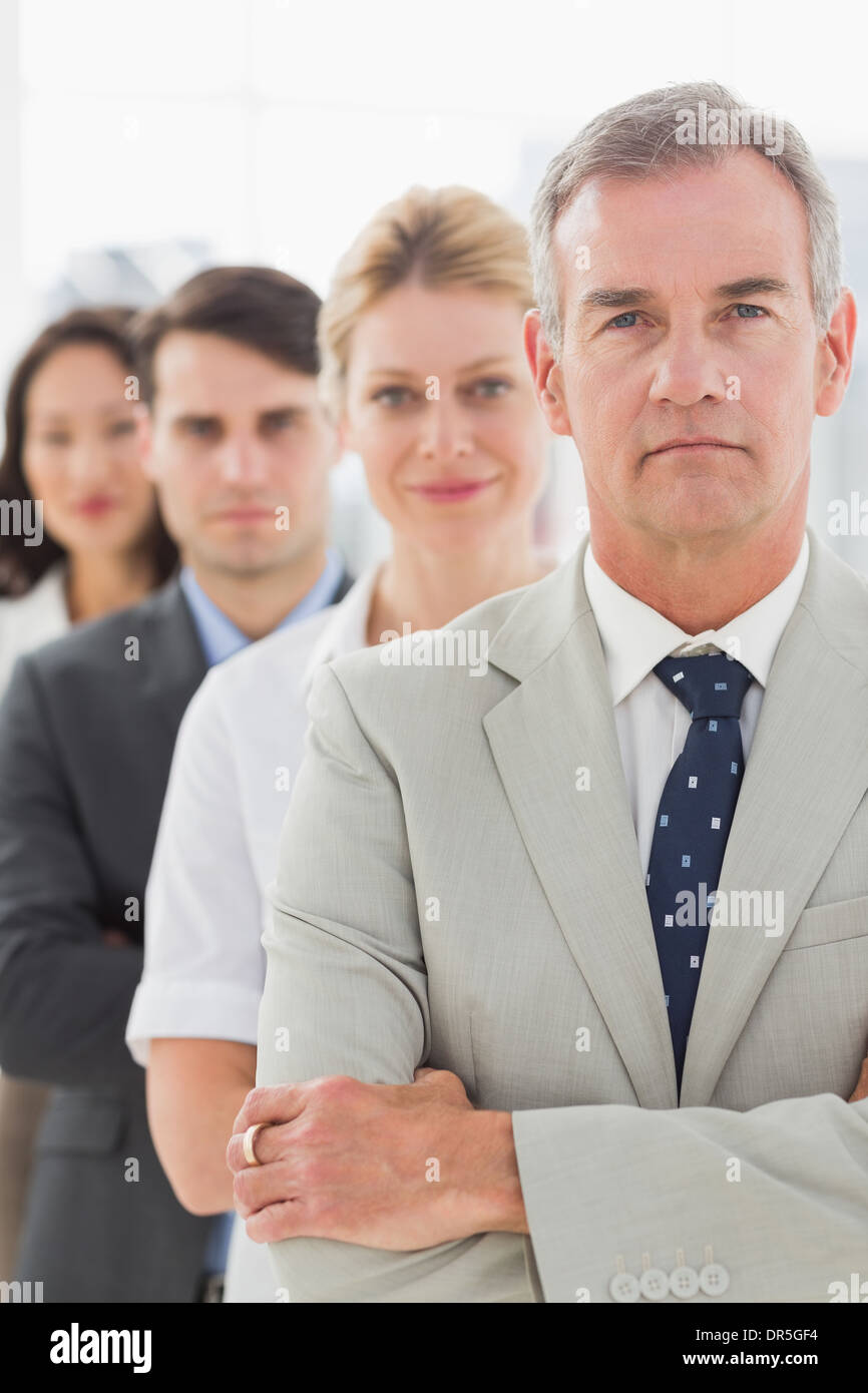 Business team standing in a line looking at camera Stock Photo - Alamy