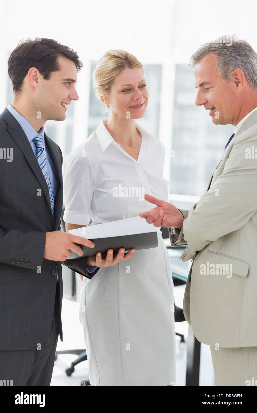 Smiling business colleagues talking together Stock Photo