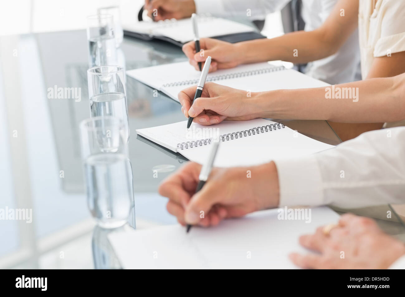 Business people taking down notes at a meeting Stock Photo