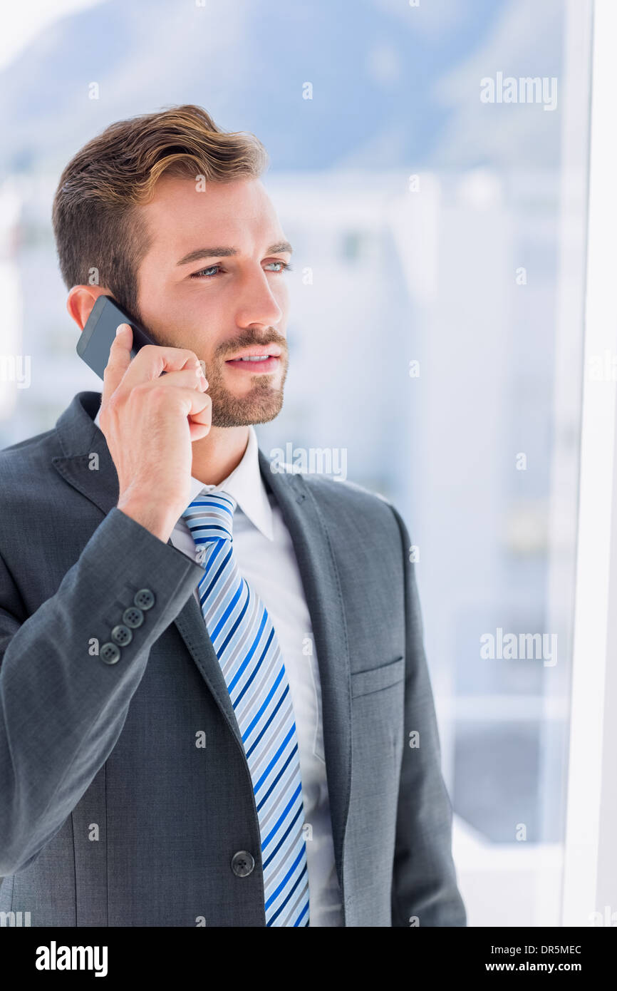 Handsome young businessman using mobile phone Stock Photo