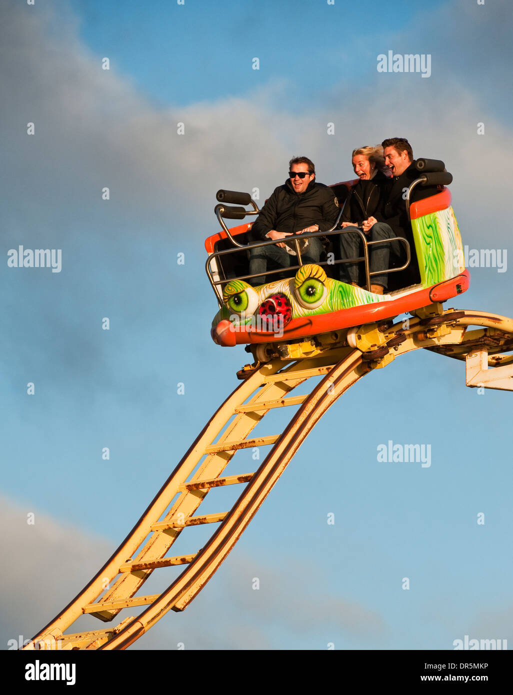 Three people on the Crazy Mouse roller coaster ride on Brighton Pier, UK Stock Photo
