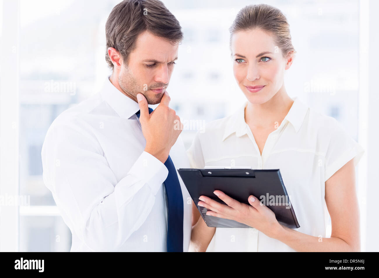 Smartly dressed colleagues using digital tablet Stock Photo