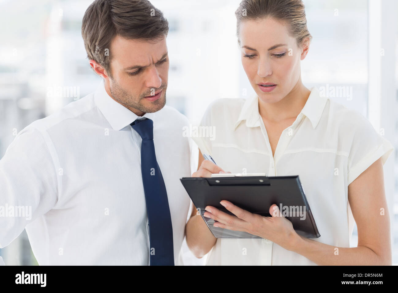 Smartly dressed colleagues using digital tablet Stock Photo