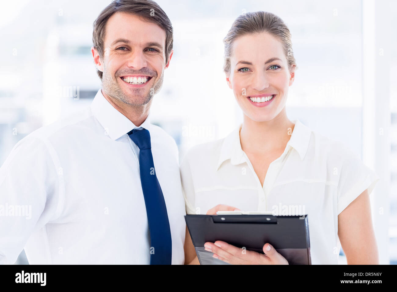 Smartly dressed colleagues using digital tablet Stock Photo