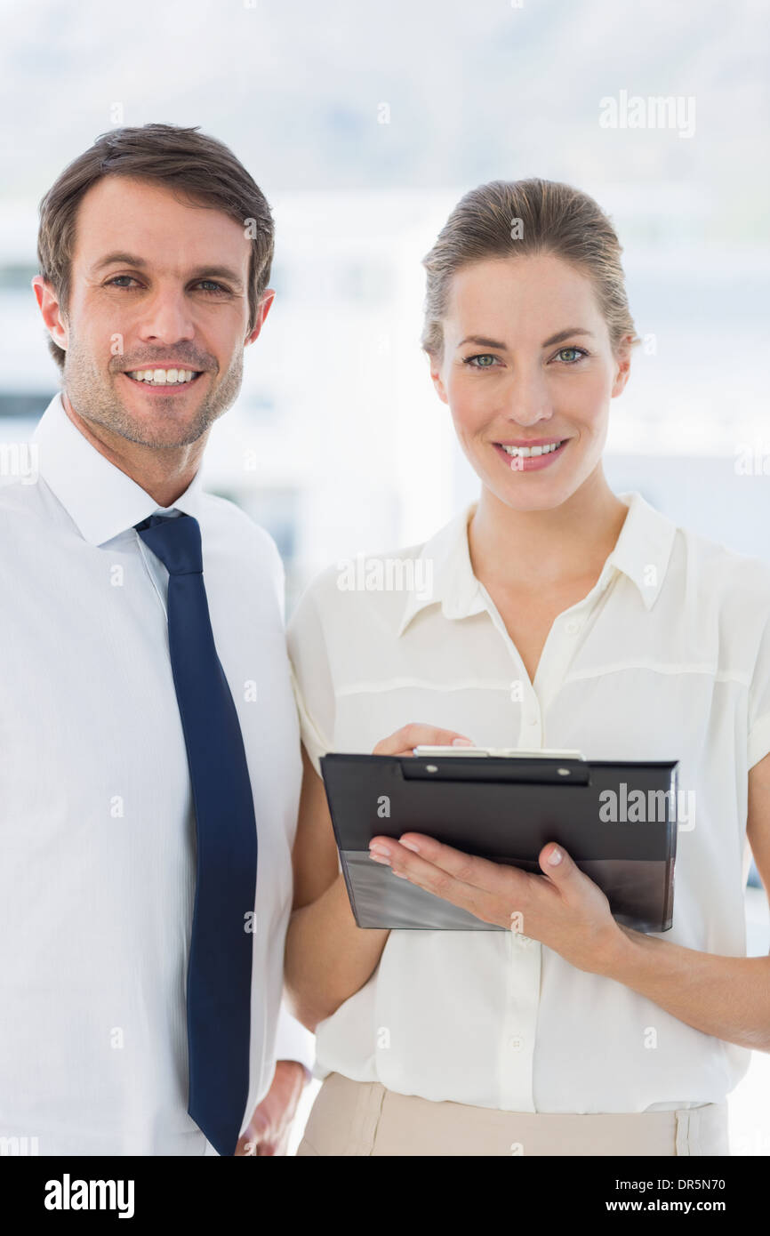 Smartly dressed colleagues using digital tablet Stock Photo