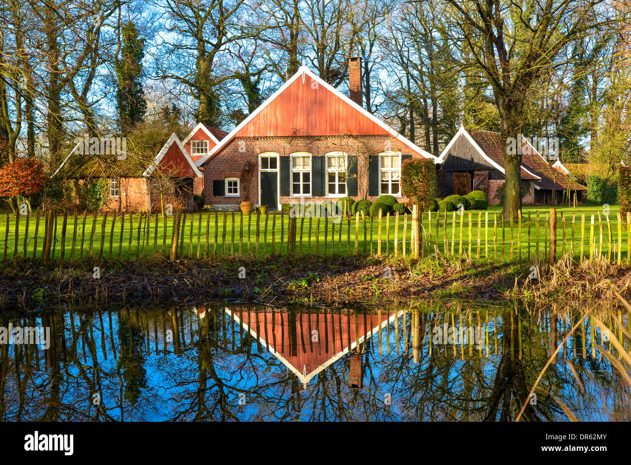 old farm and reflection in poind in the east part of Holland, so called Achterhoek Stock Photo
