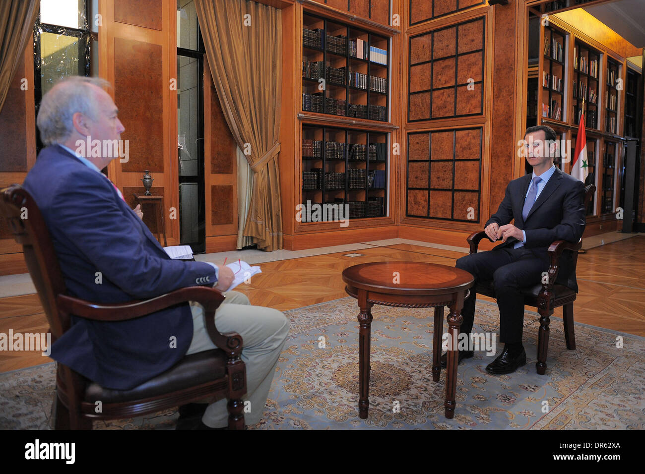 Beijing, Syria. 20th Jan, 2014. Syrian President Bashar al-Assad (R) speaks during an interview with AFP at the presidential palace in Damascus, Syria, Jan. 19, 2014. Credit:  SANA/Xinhua/Alamy Live News Stock Photo