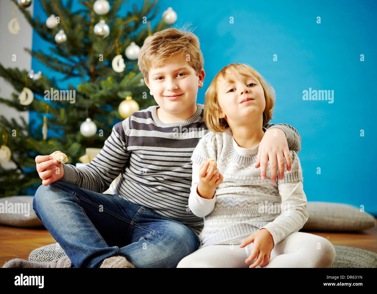Children eating Christmas cookies, Munich, Bavaria, Germany Stock Photo