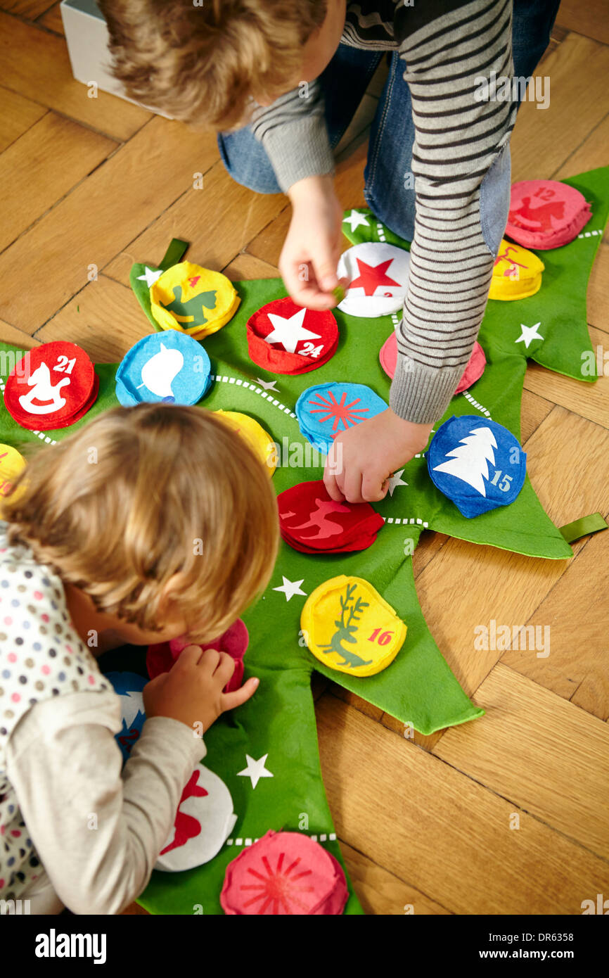 Children decorating Advent calendar, Munich, Bavaria, Germany Stock Photo