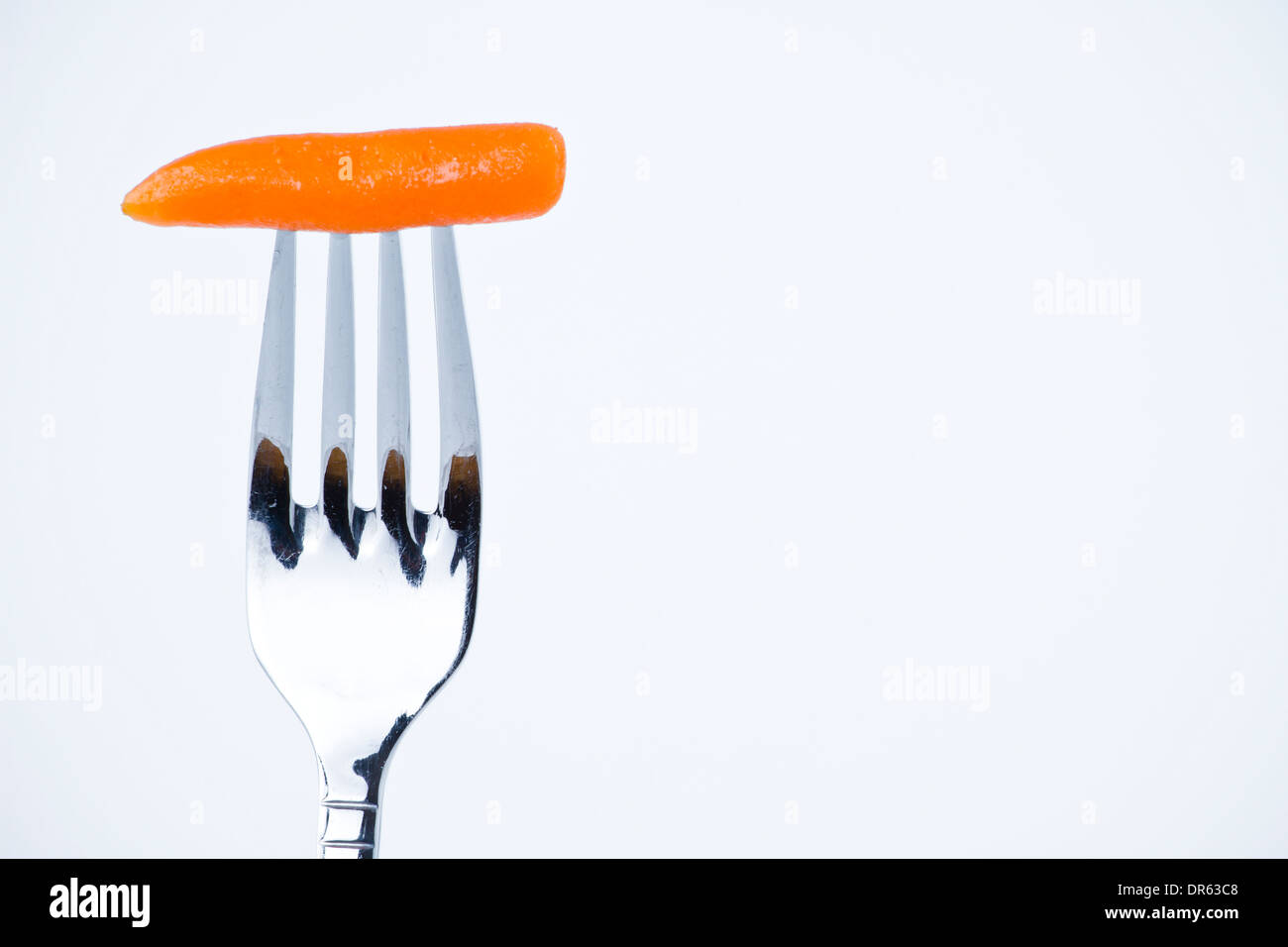 diet, carrot bite in a fork Stock Photo Alamy