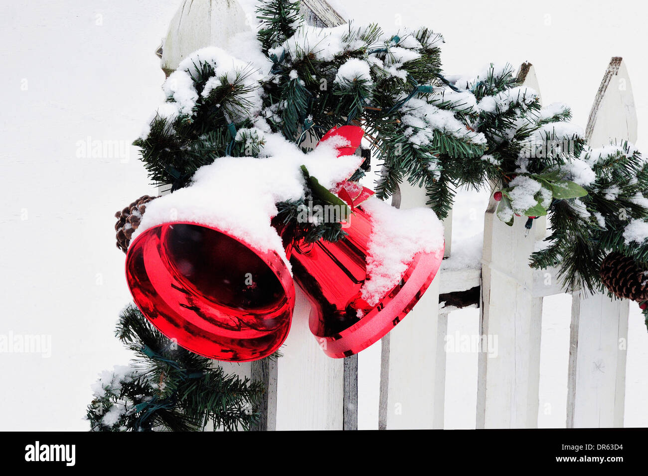 Christmas Decorations On Snow Covered Front Yard Fence Stock Photo
