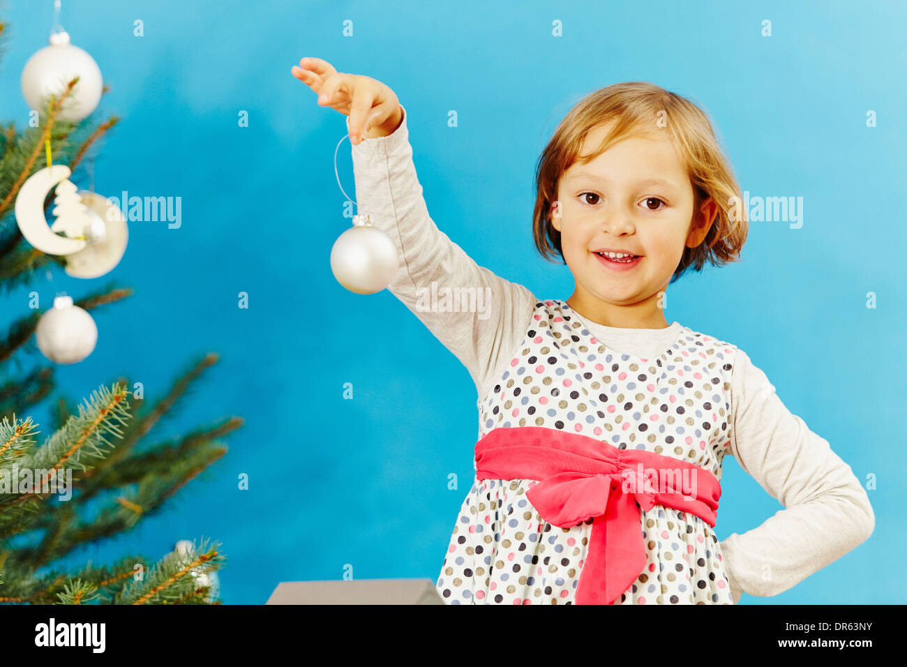 Little girl holding Christmas bauble, Munich, Bavaria, Germany Stock Photo