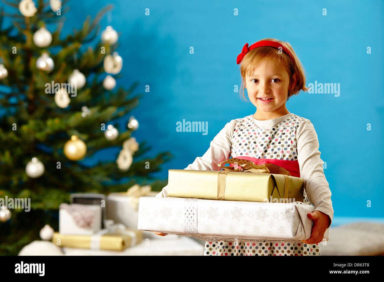 Little girl holding Christmas presents, Munich, Bavaria, Germany Stock Photo