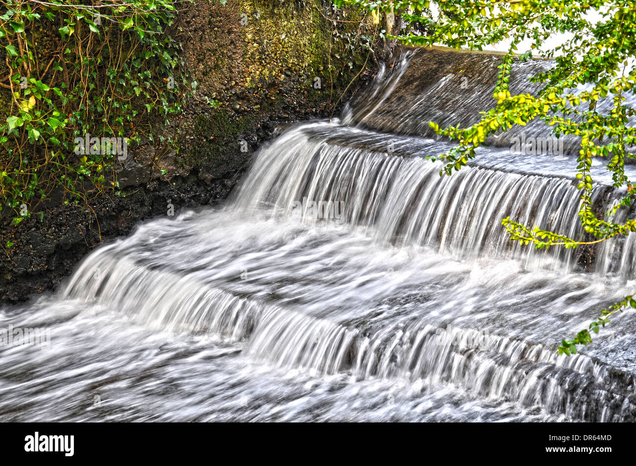 Small but fast flowing waterfall in the countryside near Brighton, England Stock Photo