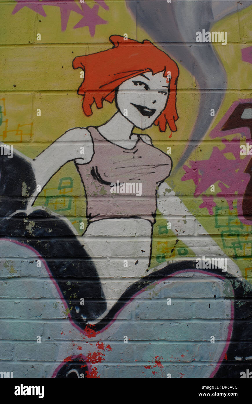 Graffiti on wall- picture of girl- ginger hair- colourful Stock Photo