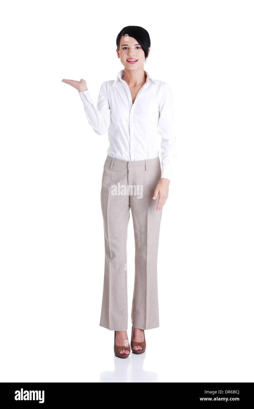 Happy young business woman showing copy space, isolated on white Stock ...