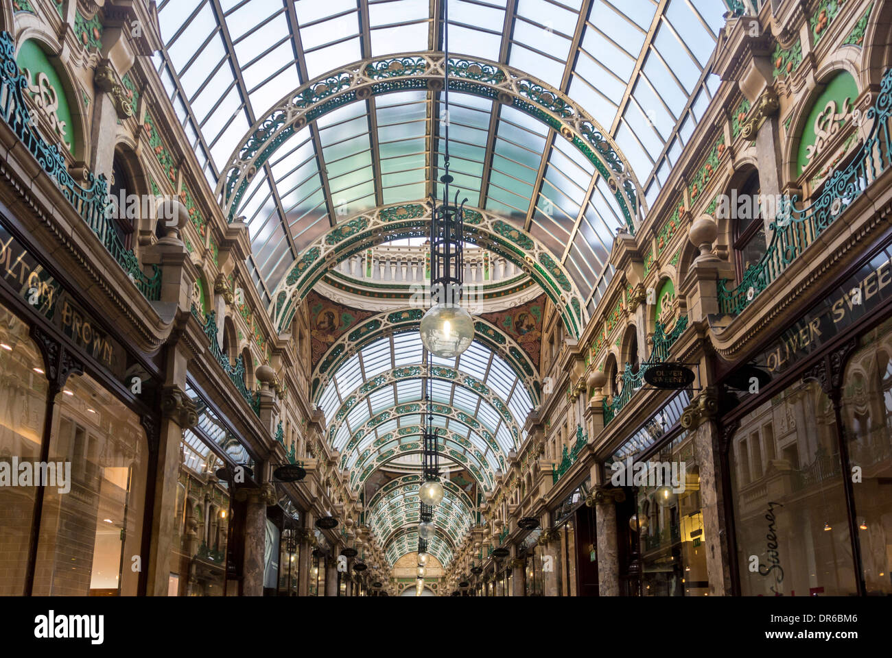 Ornate cast-iron segmental-arched roof trusses seen from the interior of County Arcade, Victoria Quarter, Leeds. Stock Photo