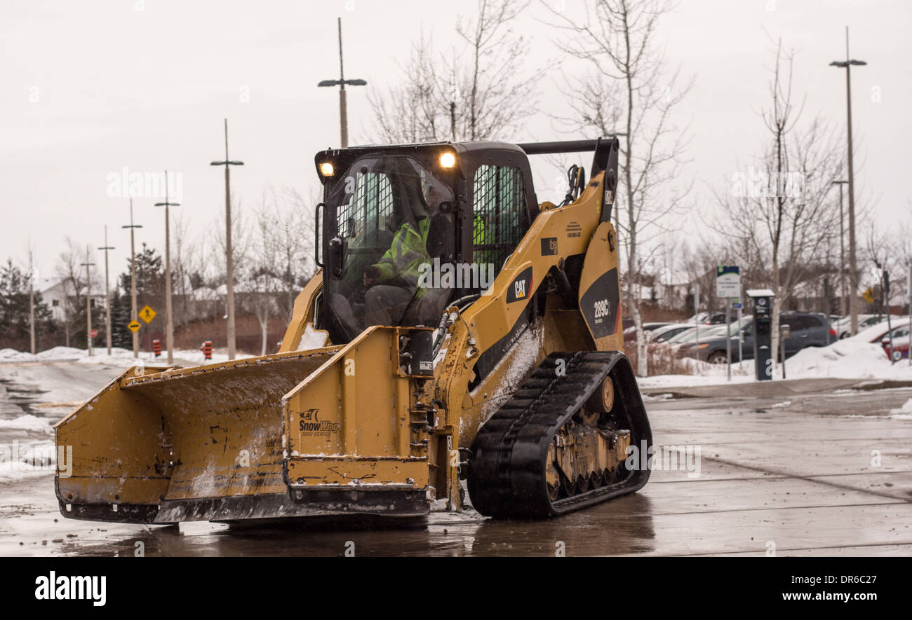 Caterpillar skid steer with snow plow Stock Photo Alamy