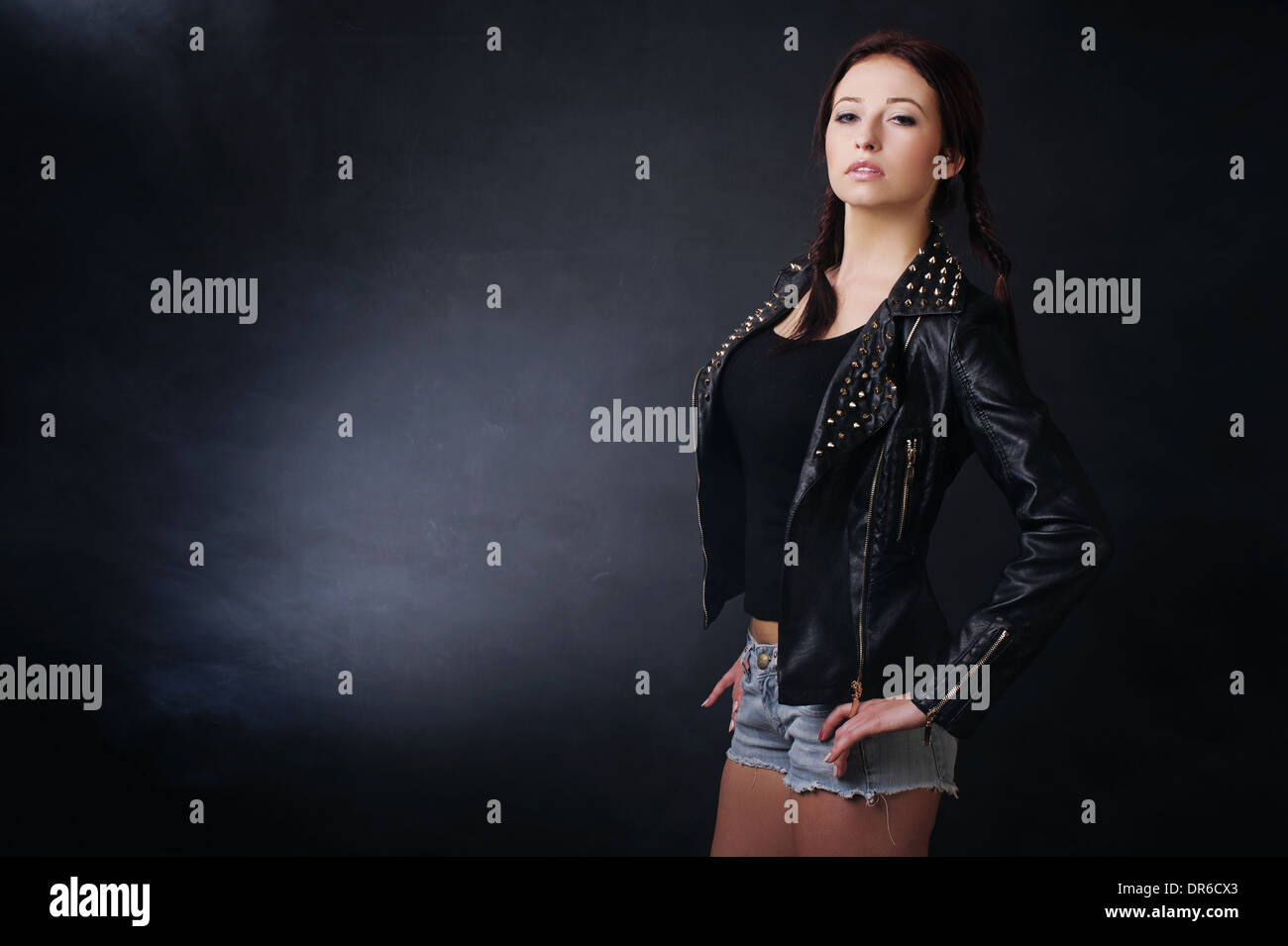 Young wife stylishly dressed in a dark background Stock Photo