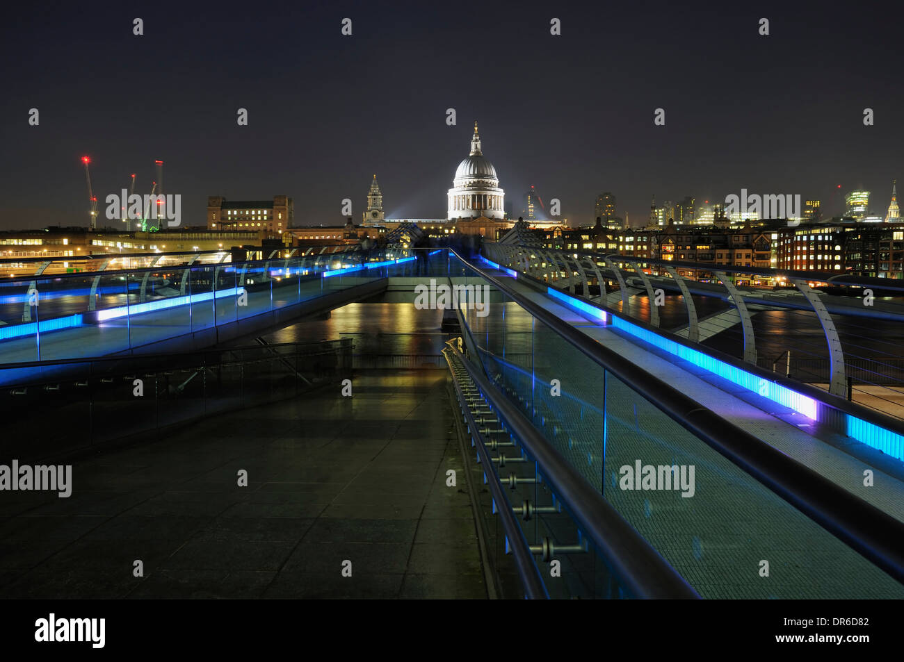 The Millennium Bridge and St Paul's Cathedral, London UK,  illuminated at night Stock Photo