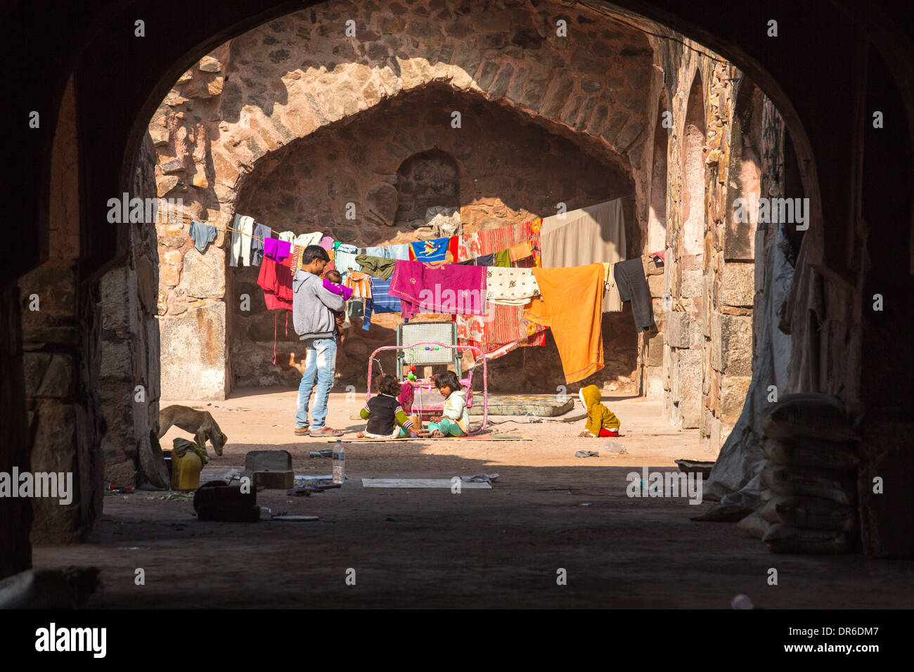 A poor family making their home in old tunnels in the Purana Qila fort in Delhi; India. Stock Photo