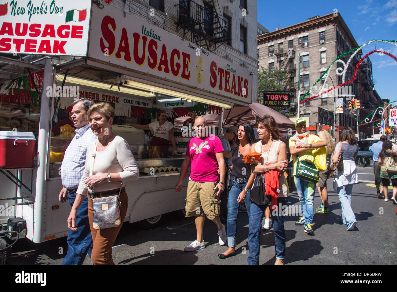 New York City USA:  Visitors walking past  food vendor during the annual Feast of San Gennaro in Little Italy Sept 13, 2013 Stock Photo