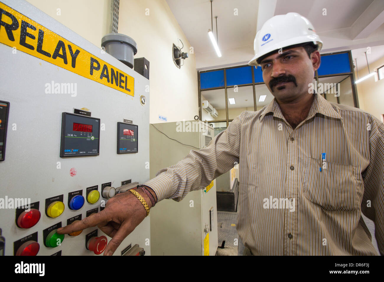 Workers at a 1 MW solar power station run by Tata power on the roof of