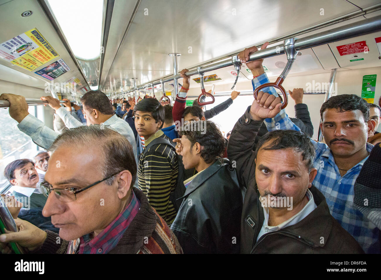 Commuters in a railway carriage on the Delhi Metro, Delhi, India. Stock Photo