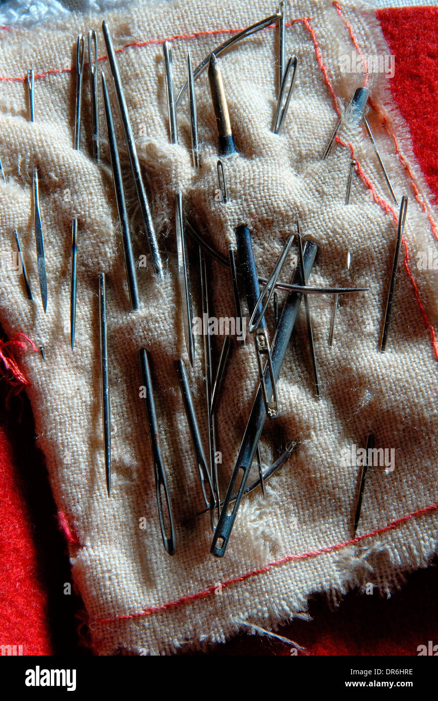 Needles stuck on cloth Stock Photo