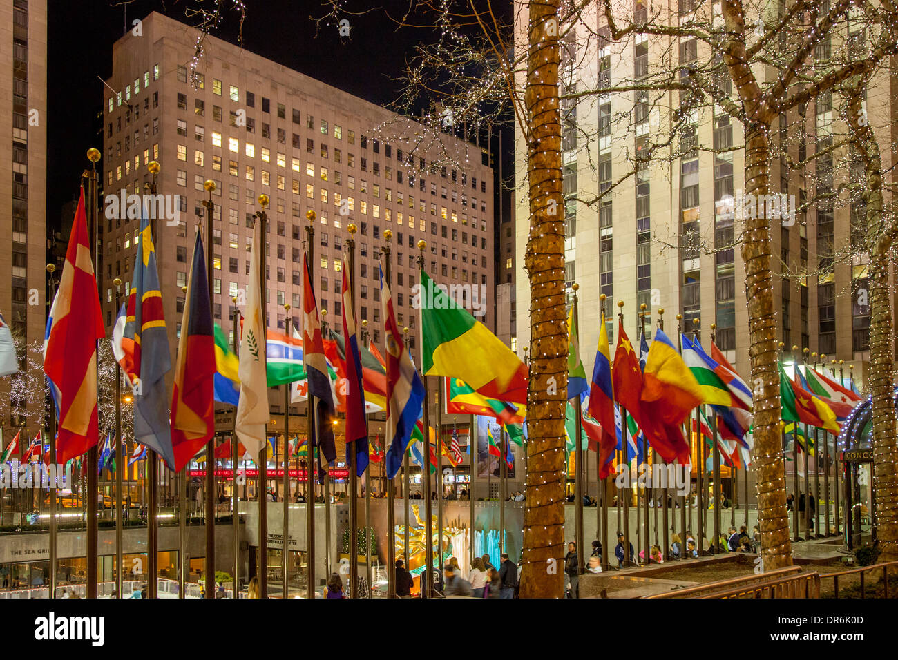 International flags surround the ice rink at Rockefeller Center, Manhattan, New York City, USA Stock Photo