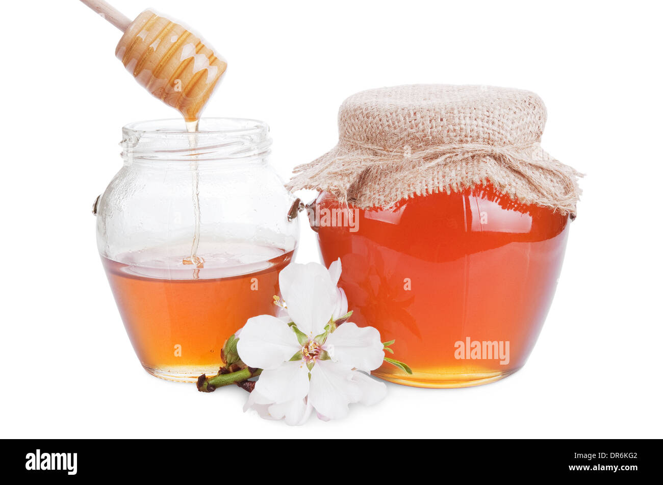 glass jars with honey and wooden stick isolated on white background Stock Photo