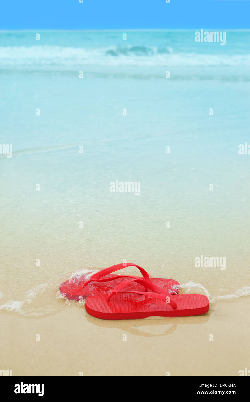 Red flip flops on the beach sand.Concept of summer vacations Stock ...
