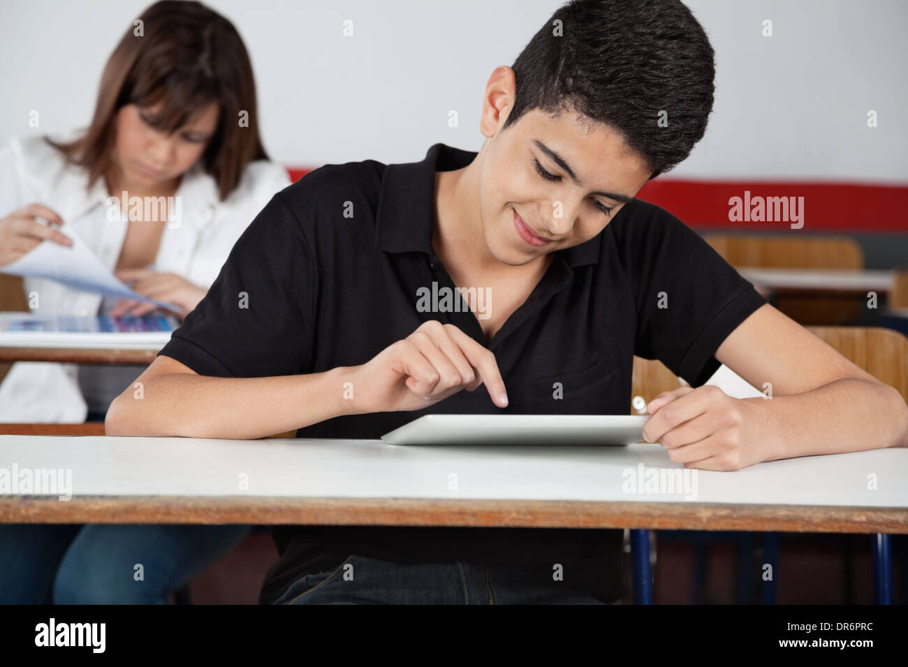 High School Student Using Digital Tablet At Desk Stock Photo