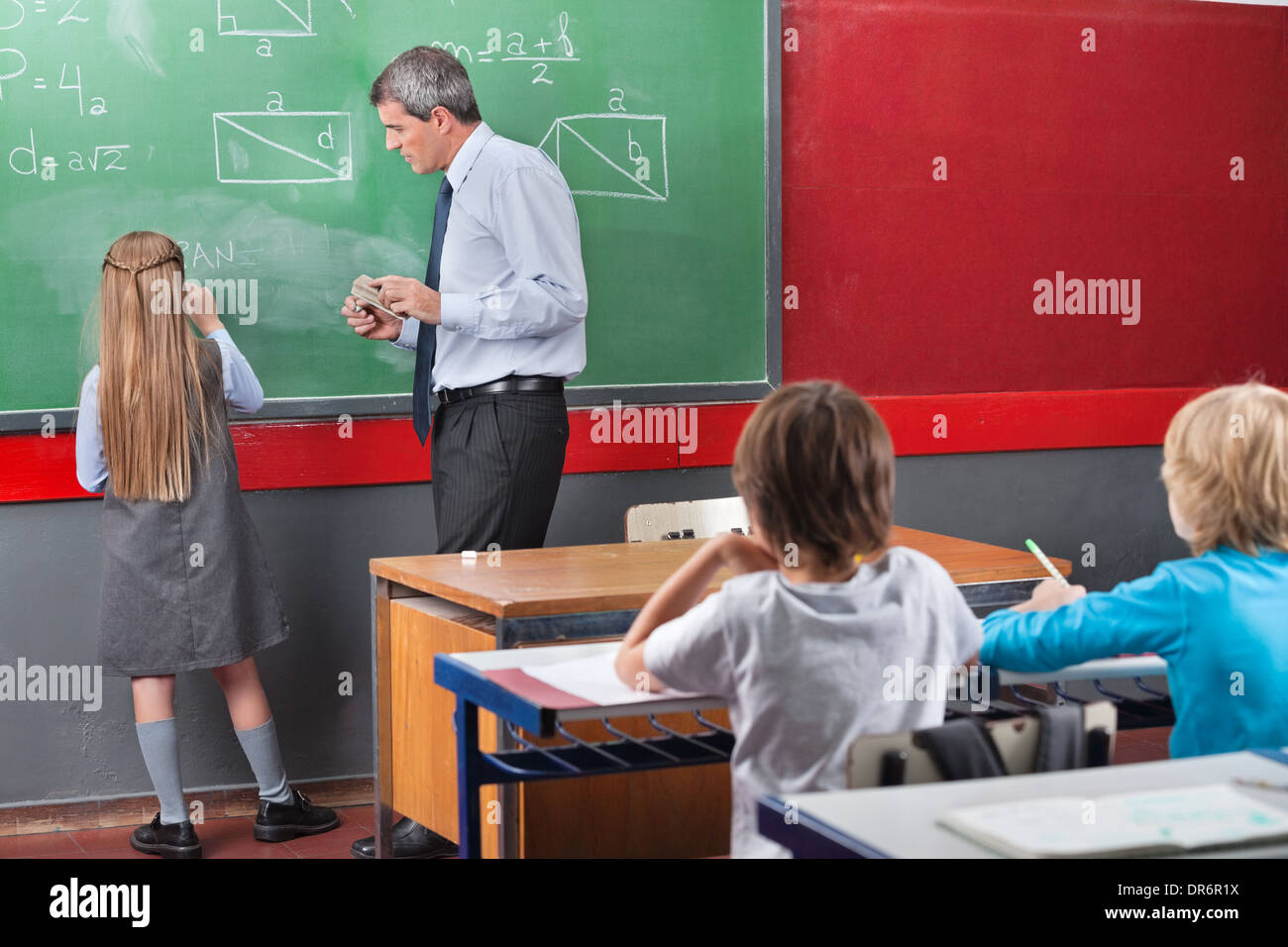 Little Schoolgirl Solving Mathematics On Board Stock Photo - Alamy