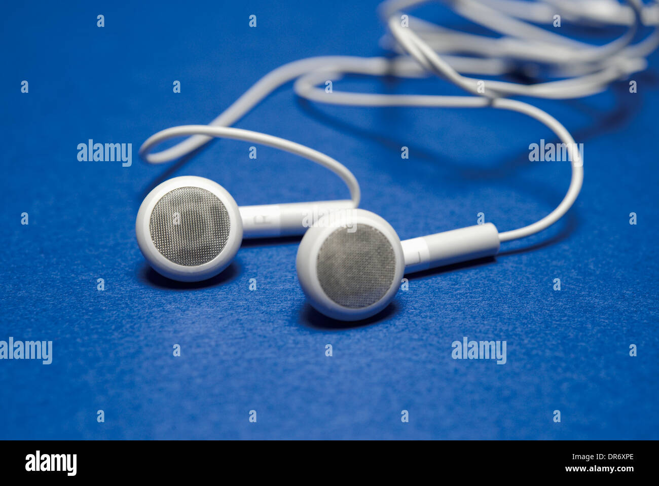 White head phones on blue ground Stock Photo