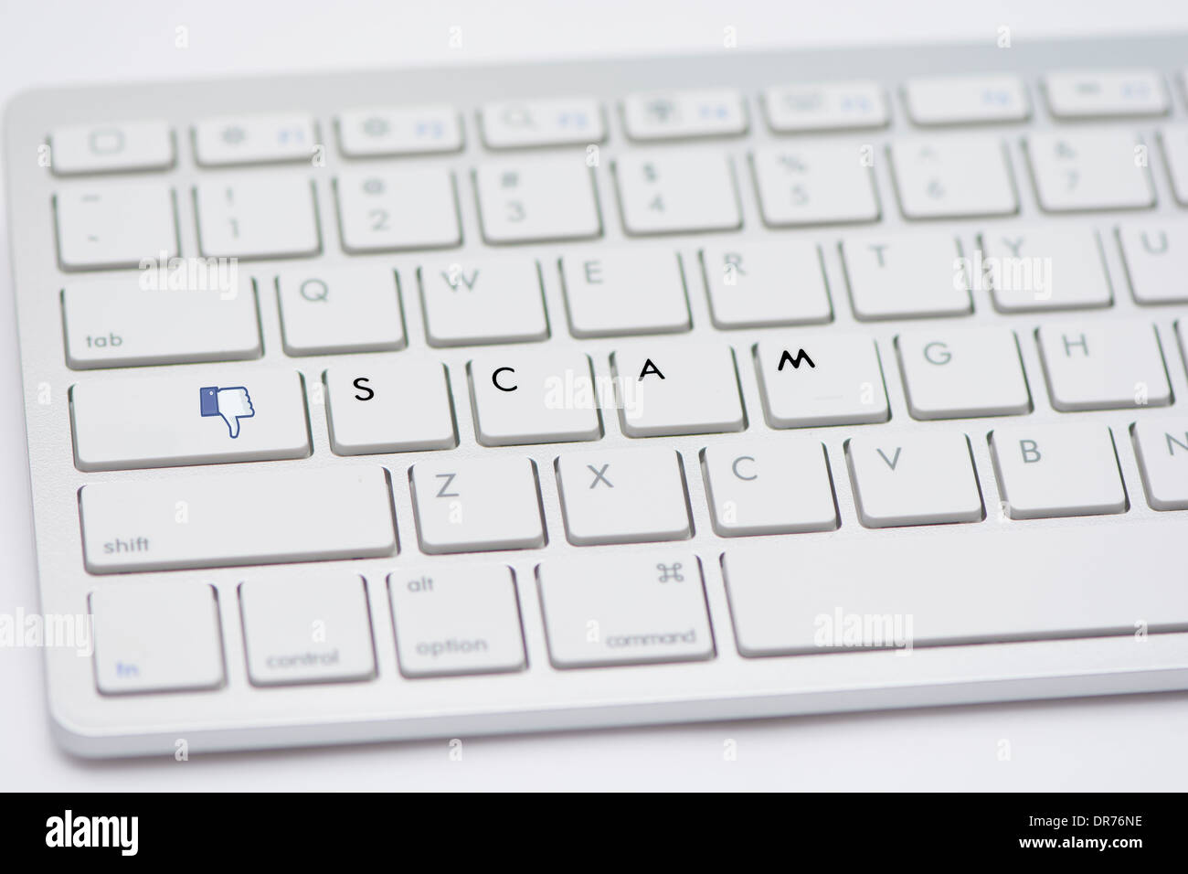 Computer Keyboard With Letters Spelling Out The Work Scam And Dislike Button Isolated On A White Studio Background Stock Photo