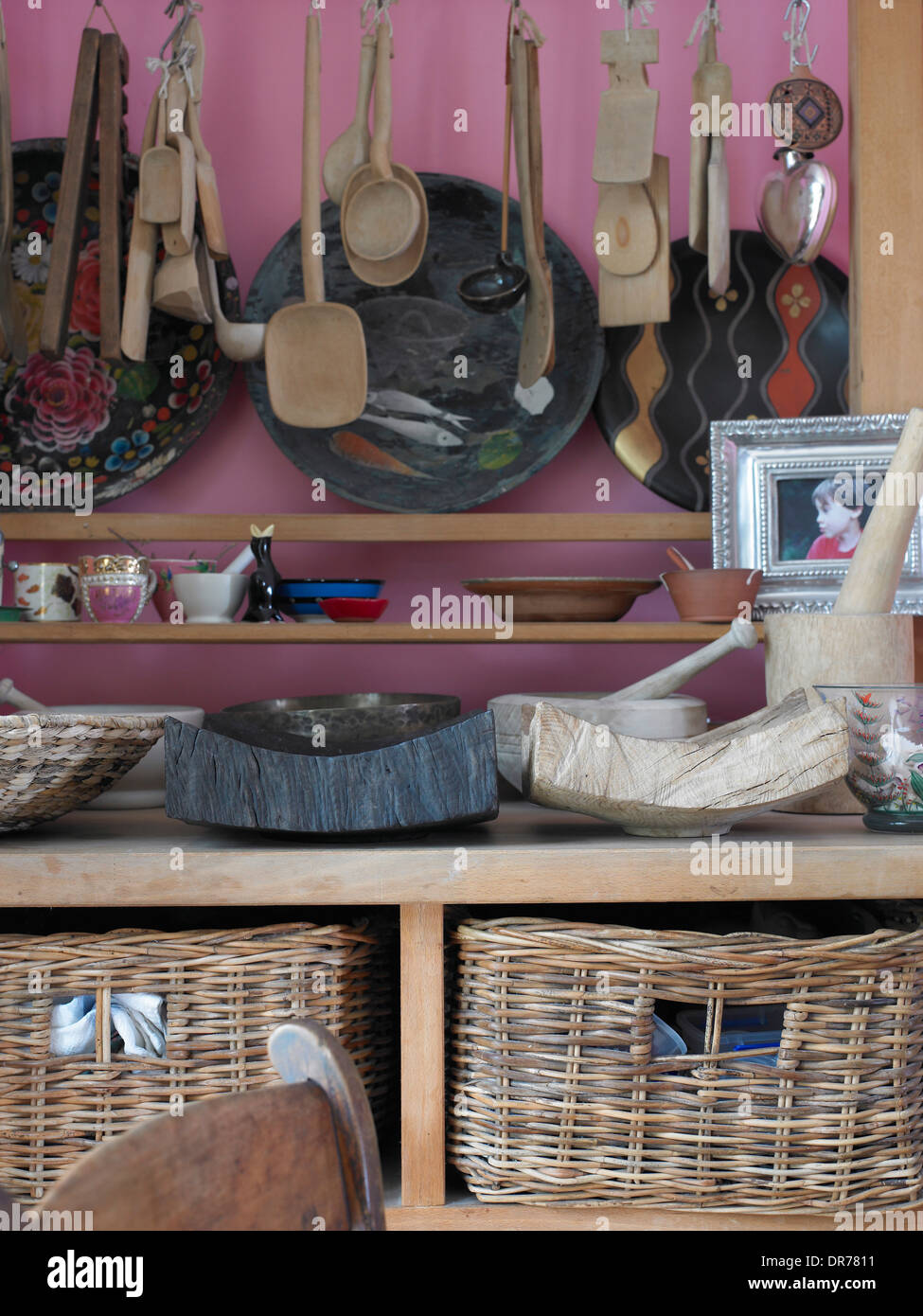 Dresser With Wicker Baskets And Assorted Wooden Spoons And Bowls