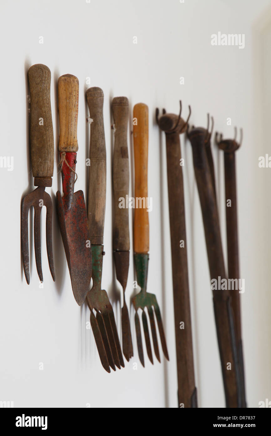 Close up of garden tools hanging on wall, Barnsley House Hotel, Barnsley, Cotswolds Stock Photo